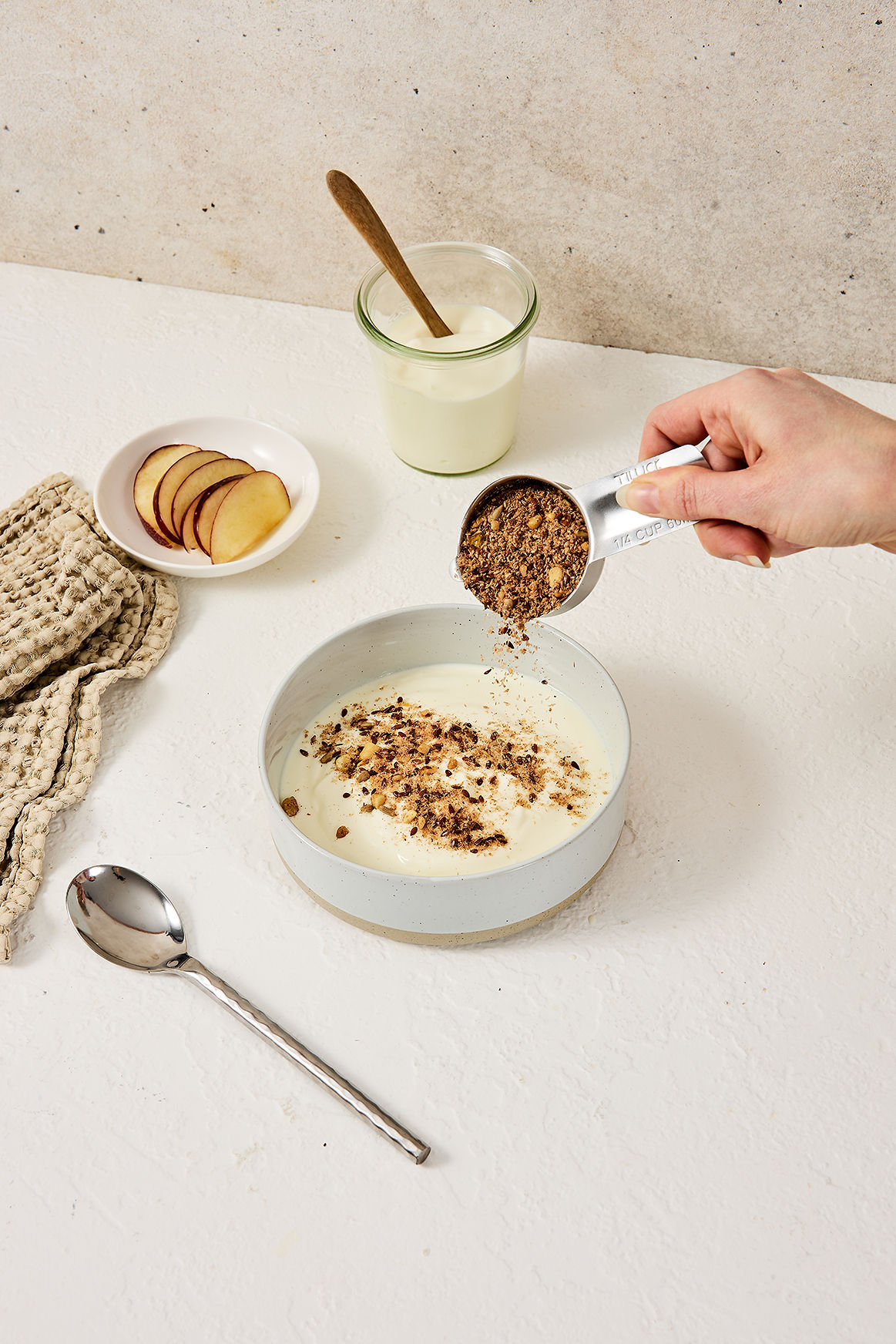 Adding a quarter-cup scoop of My Daily Gut to yoghurt