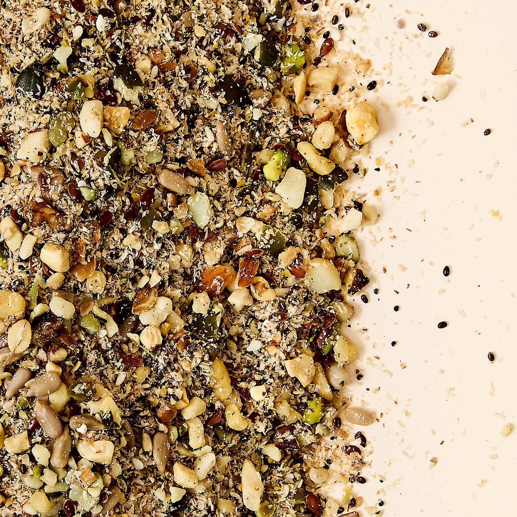 Close-up texture of My Daily Gut Digestion Blend showing the 30 diverse plant ingredients — seeds, nuts, whole grains and legumes — on a warm neutral background